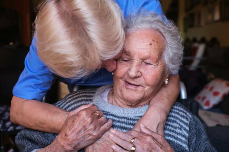 Known Memory Care | Senior and caregiver embrace