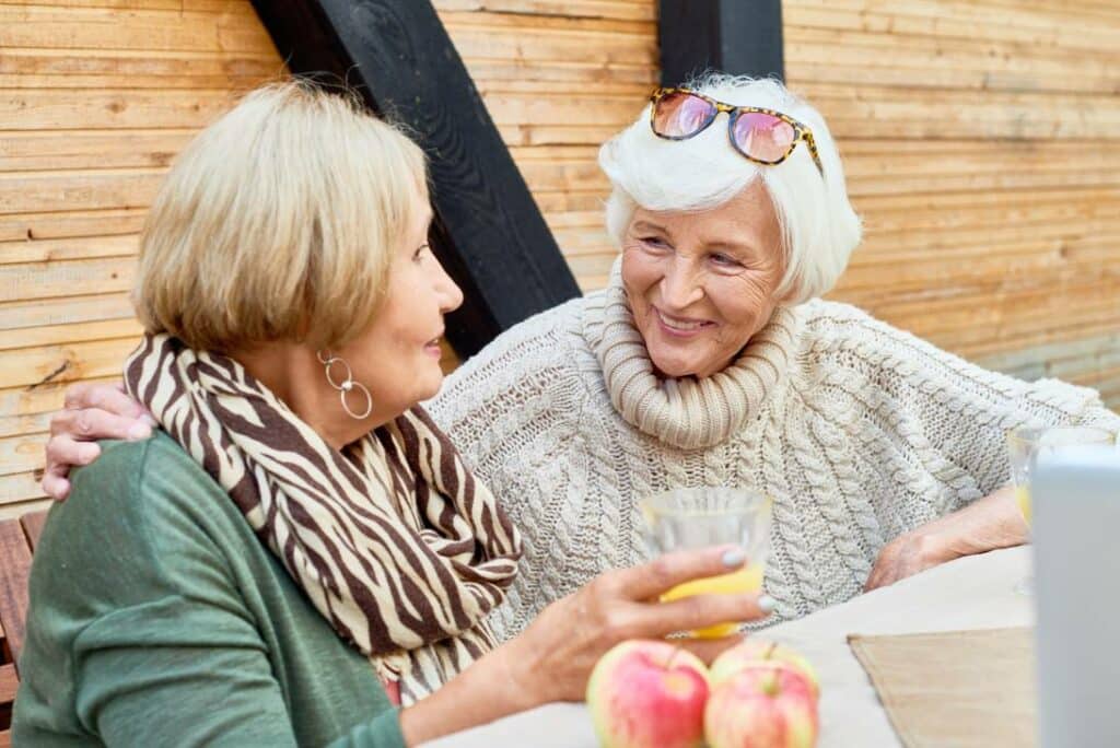 Known Memory Care | senior women talking over meal
