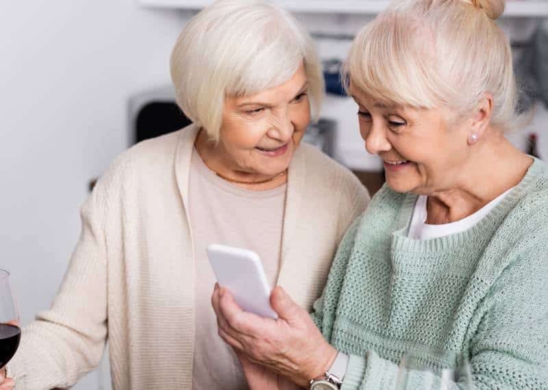 Known Memory Care | senior women looking at phone