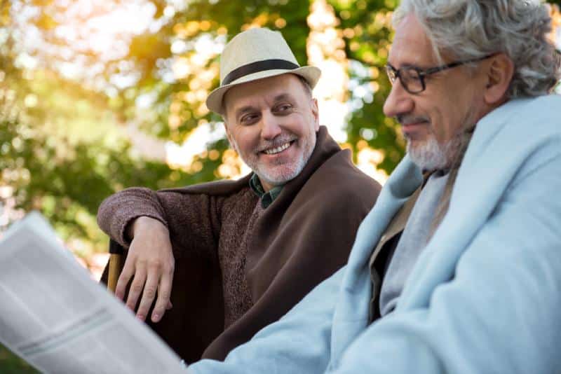 Known Memory Care | Seniors reading outside