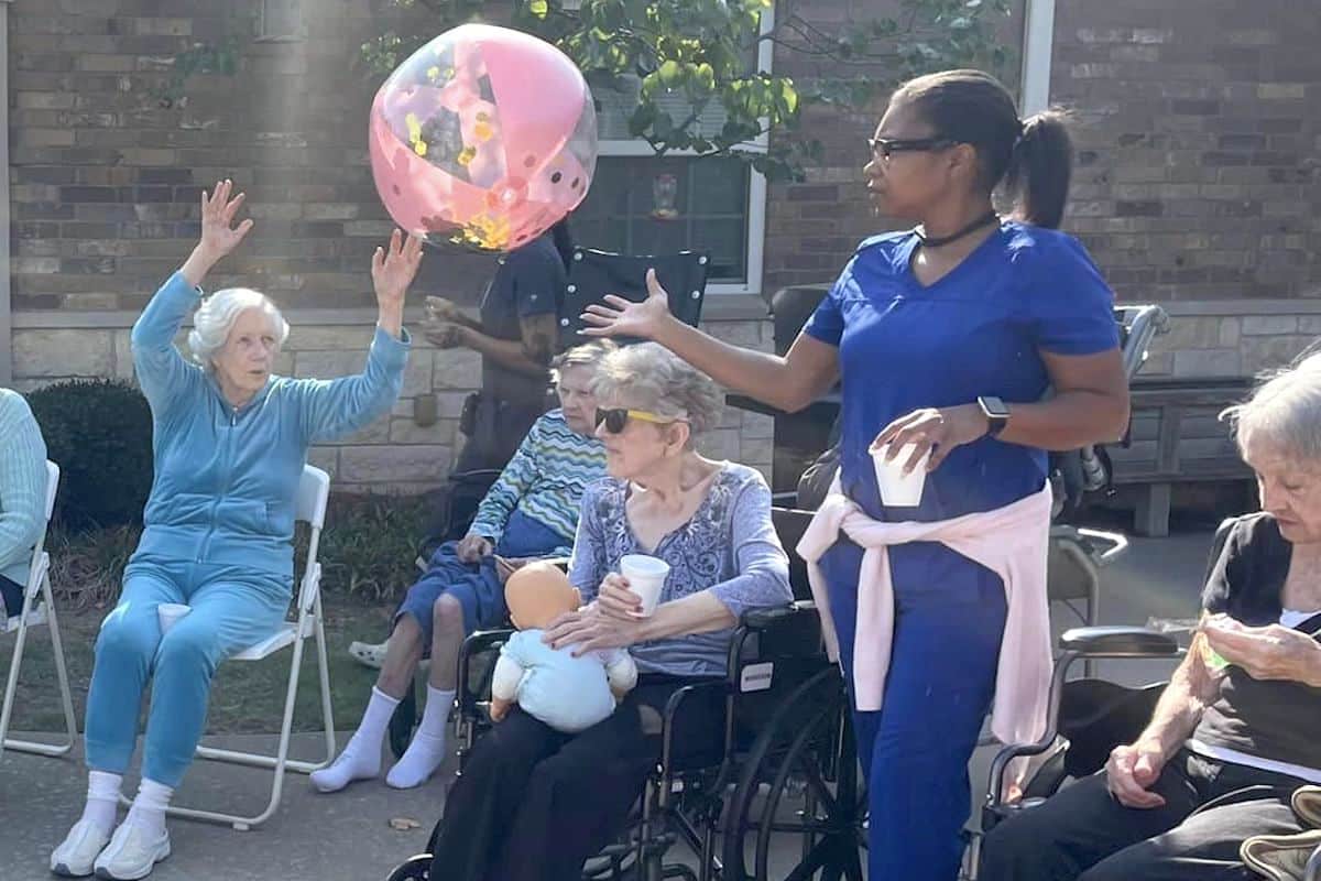 Known Memory Care | Seniors passing the beach ball outside
